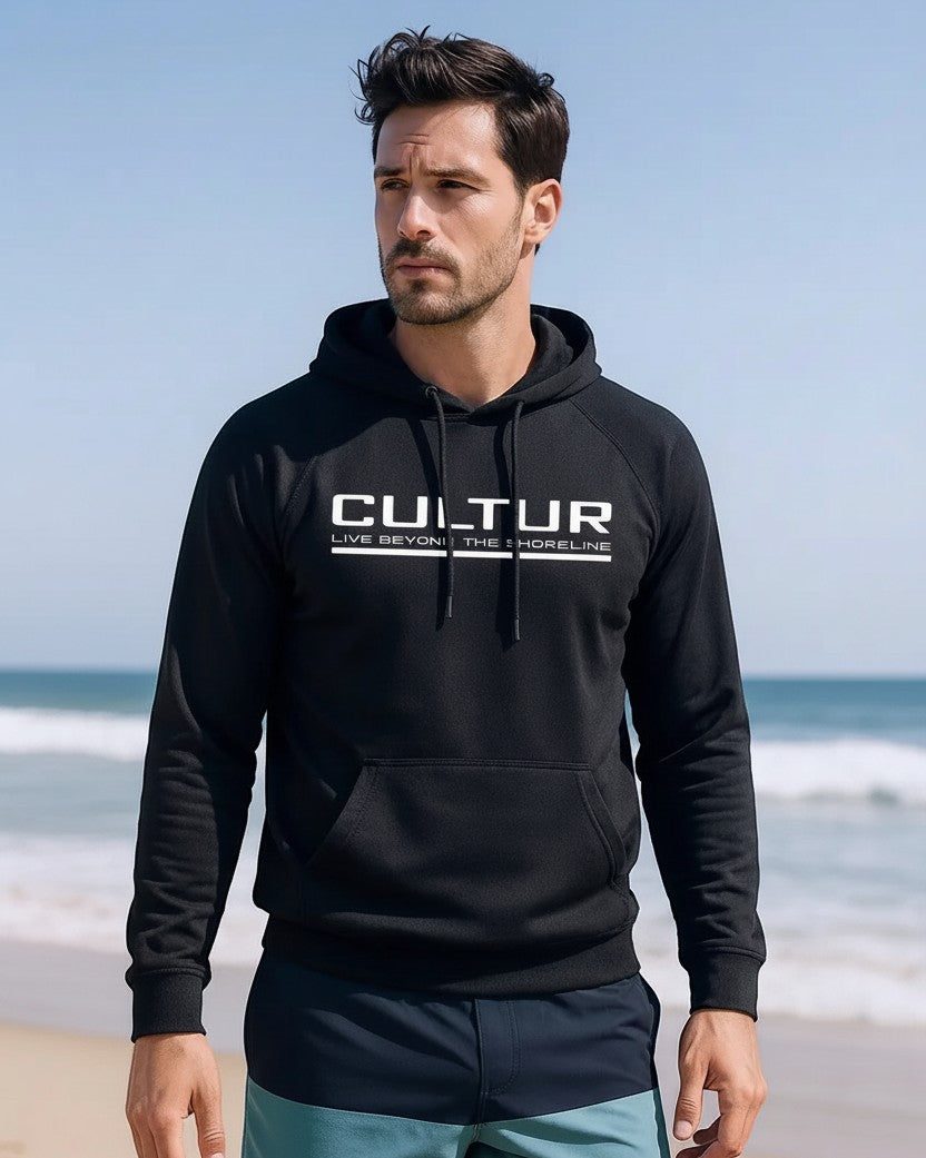 CULTUR black microfiber performance polyester hoodie with white logo and camo sleeve accents, worn by a man on a beach.