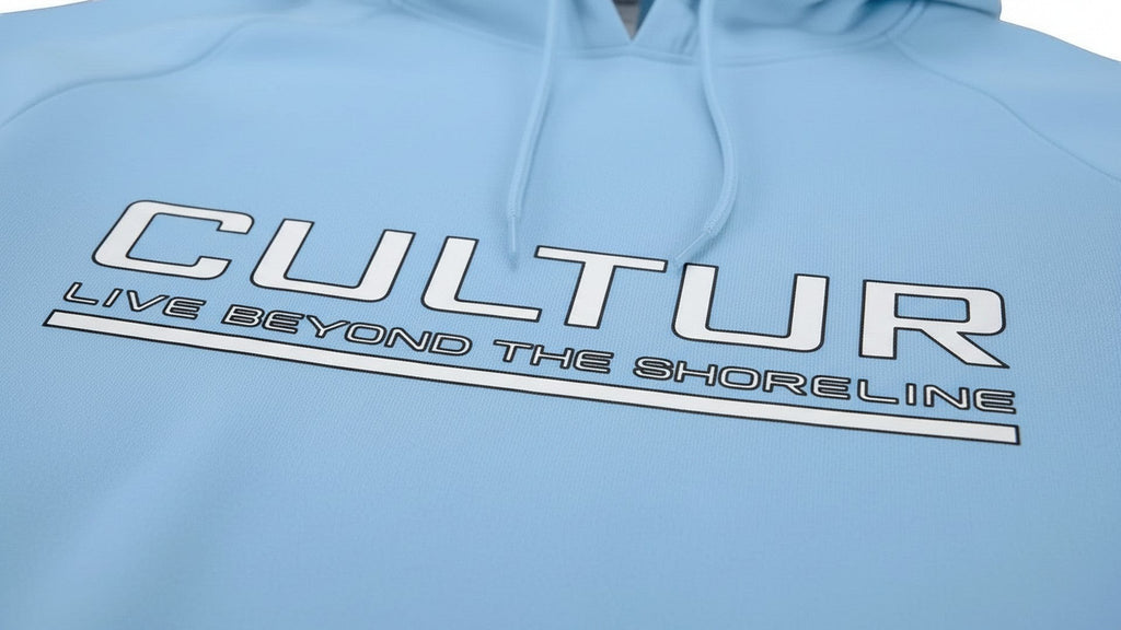 CULTUR blue mist microfiber performance polyester hoodie with logo and text "LIVE BEYOND THE SHORELINE"